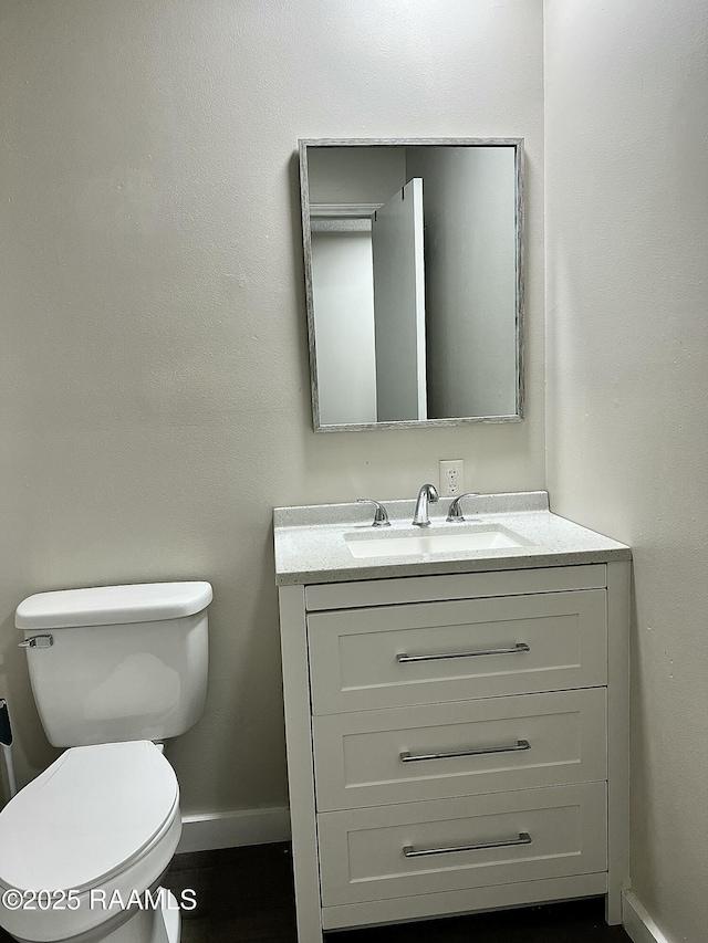 151 Kenneth Boagni Sr Dr, Opelousas, LA 70570 - bathroom featuring baseboards, vanity, and toilet