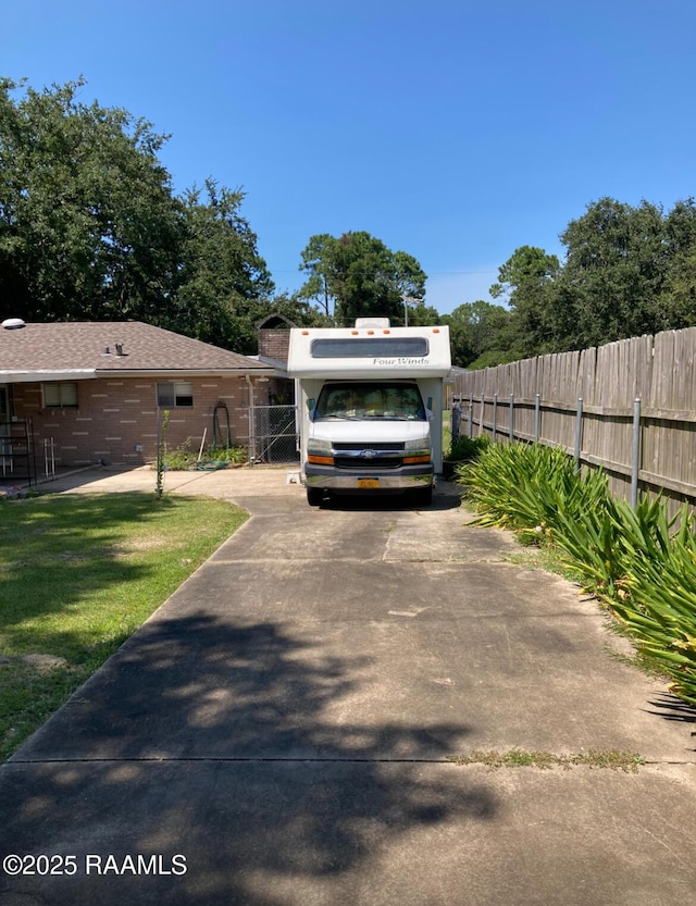 exterior space featuring fence and a lawn