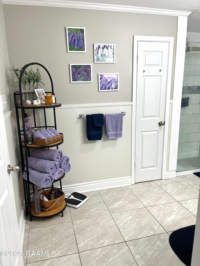 full bathroom with baseboards, a stall shower, tile patterned floors, and crown molding