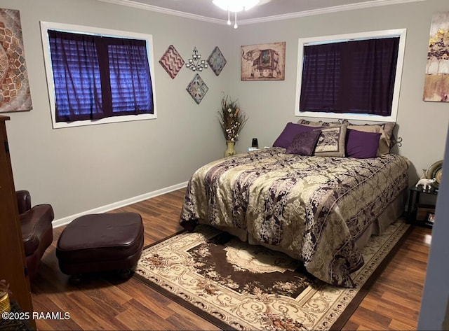 bedroom featuring ornamental molding, wood finished floors, and baseboards