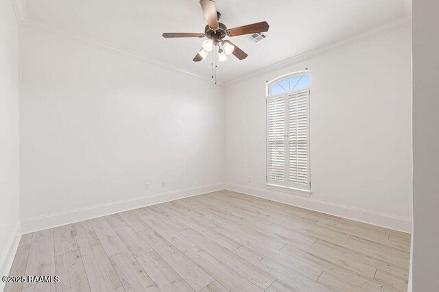 spare room featuring crown molding, visible vents, light wood-style floors, ceiling fan, and baseboards