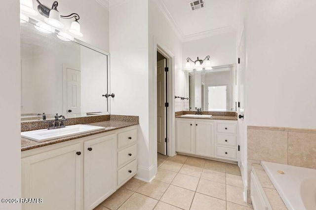 bathroom with tile patterned flooring, crown molding, visible vents, and a sink