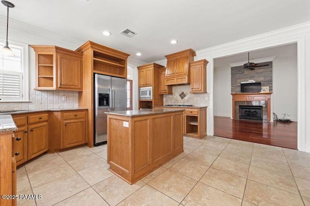 kitchen featuring appliances with stainless steel finishes, a center island, light tile patterned floors, and open shelves