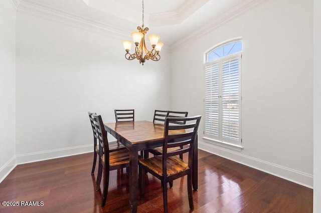 dining space with a tray ceiling, plenty of natural light, and wood finished floors