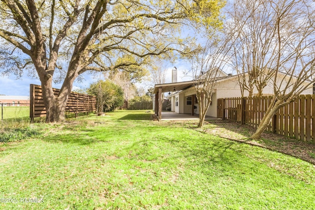 view of yard with a fenced backyard and a patio