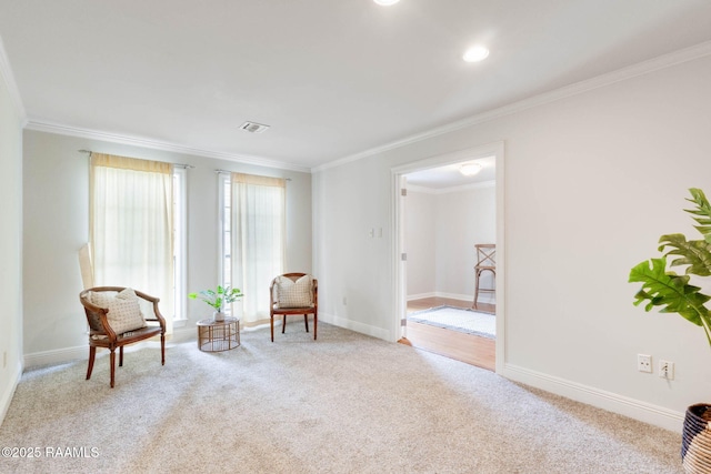 living area with crown molding, baseboards, visible vents, and carpet floors