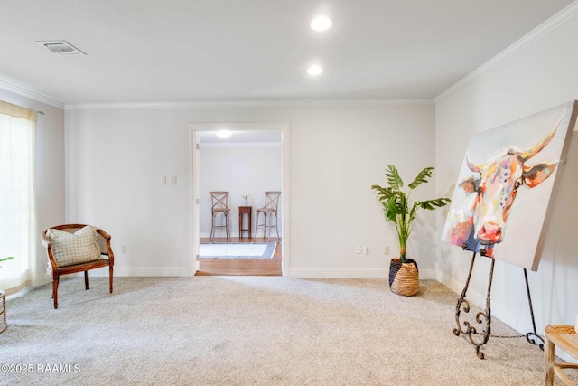 living area with carpet flooring, baseboards, and ornamental molding