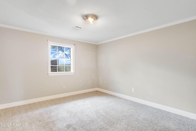 carpeted spare room featuring baseboards and ornamental molding