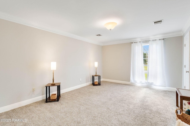 spare room with visible vents, crown molding, and carpet floors