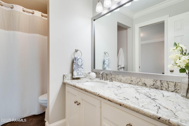 bathroom with a shower with curtain, toilet, ornamental molding, and vanity