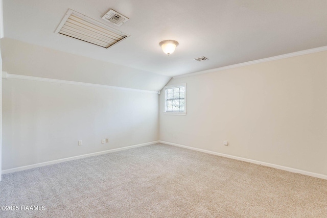 additional living space with visible vents, baseboards, carpet, and vaulted ceiling