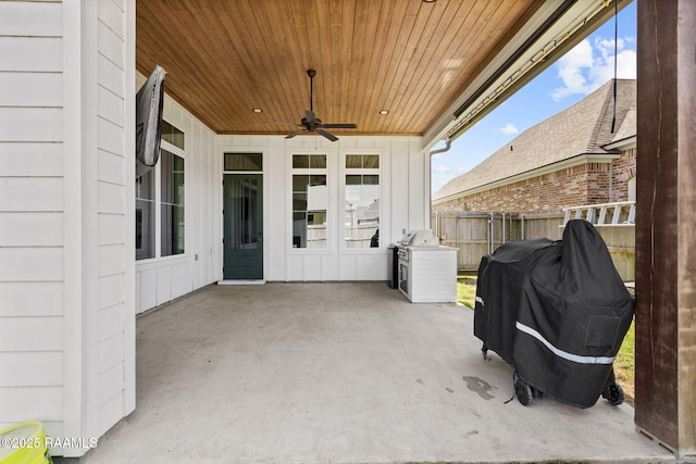 view of patio / terrace with ceiling fan and fence