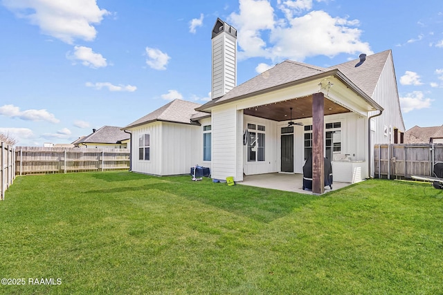 back of house featuring a yard, ceiling fan, a patio, and a fenced backyard