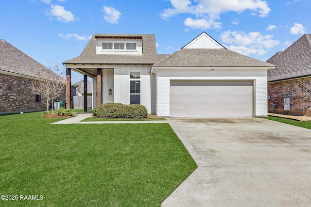 view of front of house featuring a front lawn, an attached garage, driveway, and roof with shingles