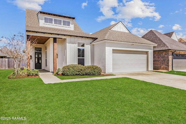 view of front of property with driveway, a shingled roof, board and batten siding, an attached garage, and a front yard