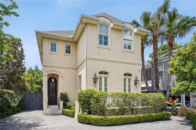 view of front of property with fence and stucco siding