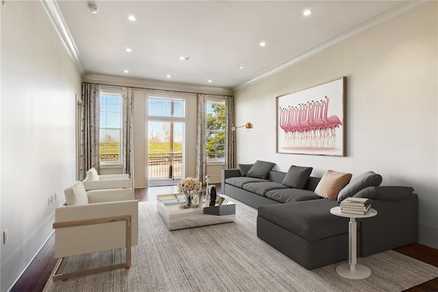 living area with baseboards, ornamental molding, wood finished floors, and recessed lighting