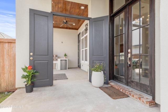 doorway to property with french doors, a patio, and stucco siding