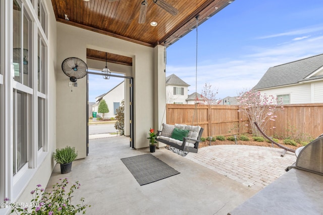 view of patio / terrace with outdoor lounge area, fence, and a ceiling fan