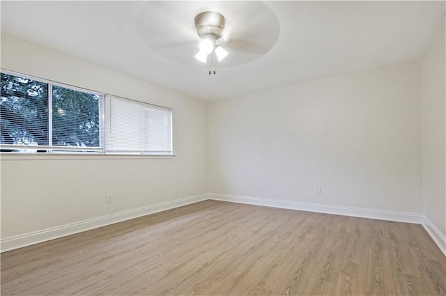 unfurnished room featuring baseboards, ceiling fan, and light wood finished floors