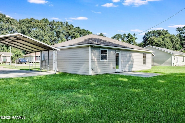 view of side of property with a carport, a lawn, and driveway