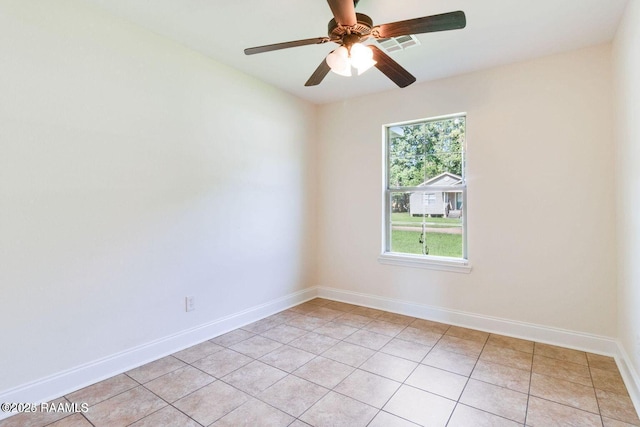 empty room with visible vents, ceiling fan, baseboards, and light tile patterned flooring