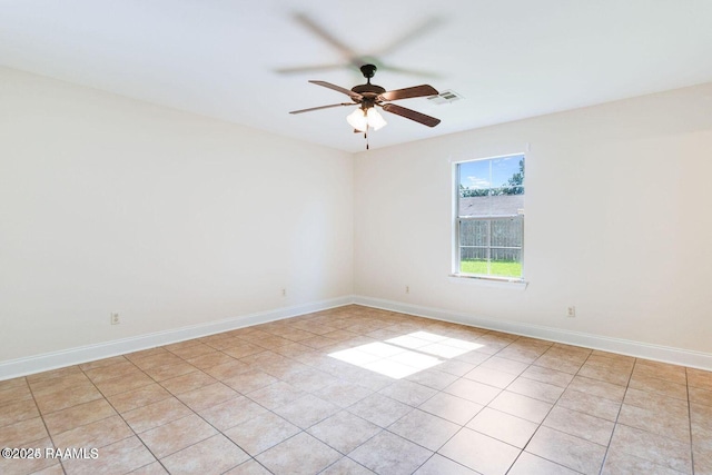 unfurnished room featuring baseboards, visible vents, a ceiling fan, and light tile patterned flooring