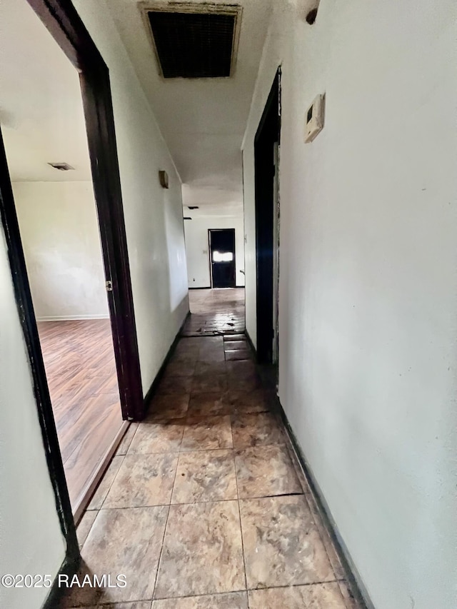 hall with light tile patterned floors and baseboards