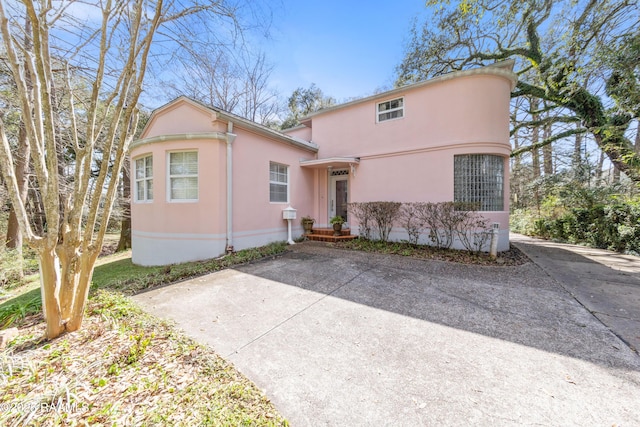 view of front facade featuring concrete driveway and stucco siding