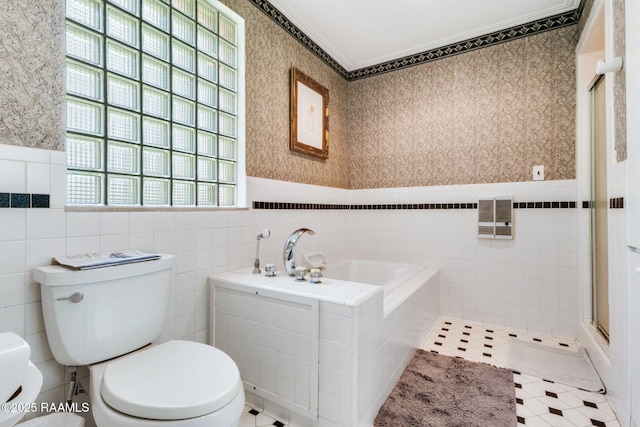 full bathroom featuring tile walls, toilet, and wallpapered walls
