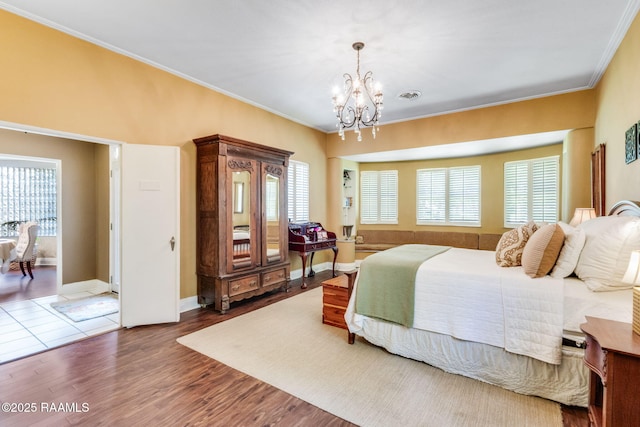 bedroom with crown molding, a chandelier, and multiple windows