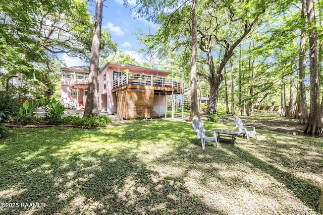 view of yard with a wooden deck and stairs