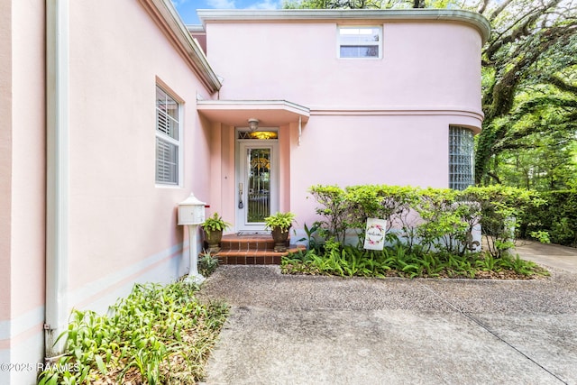 doorway to property with stucco siding