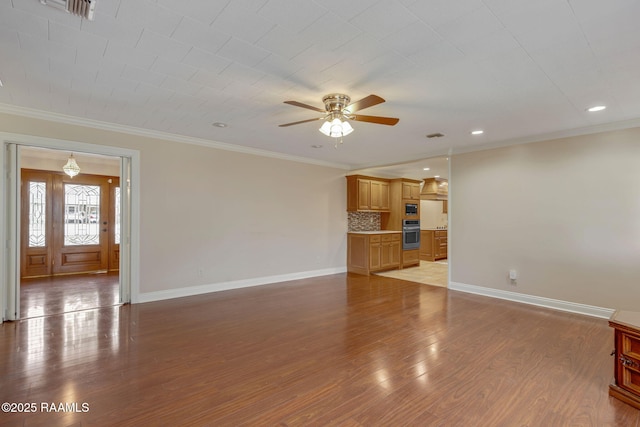 unfurnished living room featuring baseboards, ceiling fan, wood finished floors, and crown molding