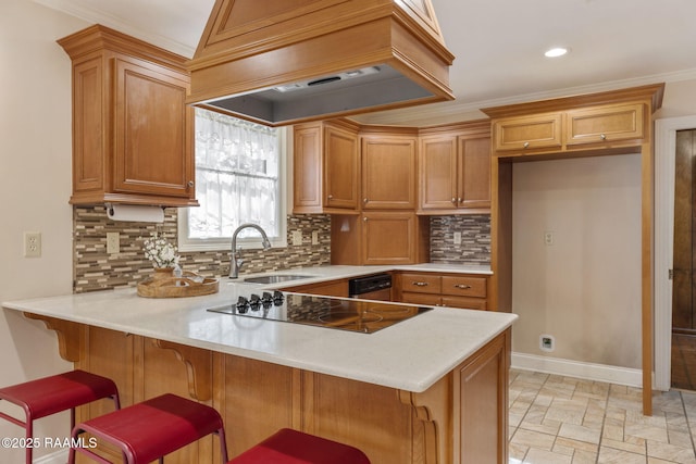 kitchen with black electric cooktop, a peninsula, a sink, light countertops, and custom exhaust hood