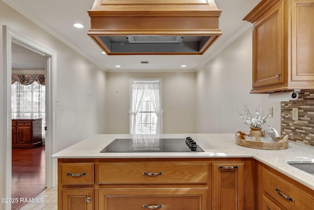 kitchen featuring light stone countertops, ornamental molding, black electric cooktop, and backsplash