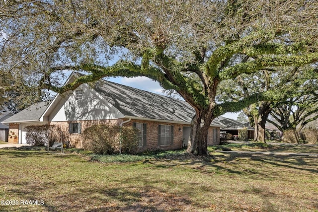201 Saxon Dr, Lafayette, LA 70508 - view of home's exterior featuring brick siding, an attached garage, and a yard