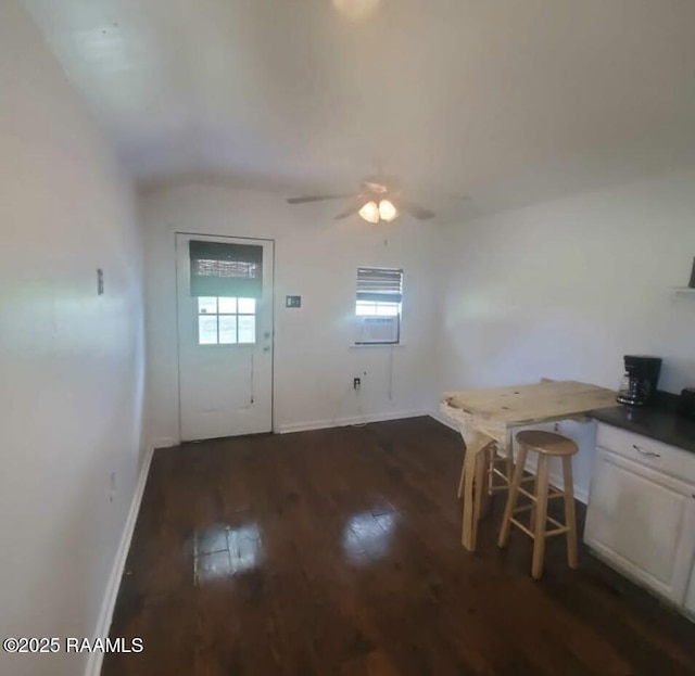 doorway to outside with vaulted ceiling, ceiling fan, baseboards, and hardwood / wood-style flooring