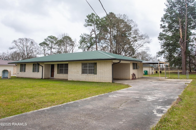 ranch-style house featuring aphalt driveway, a front lawn, an attached carport, and brick siding