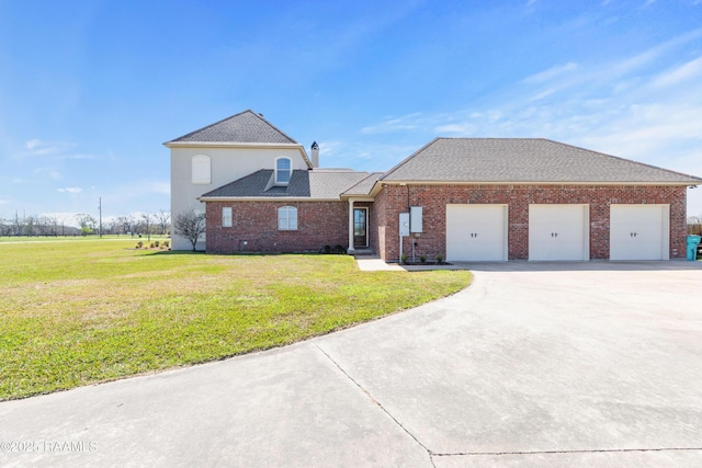 view of front of home featuring brick siding, driveway, an attached garage, and a front yard