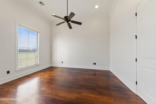 unfurnished room with baseboards, dark wood-style floors, visible vents, and ornamental molding