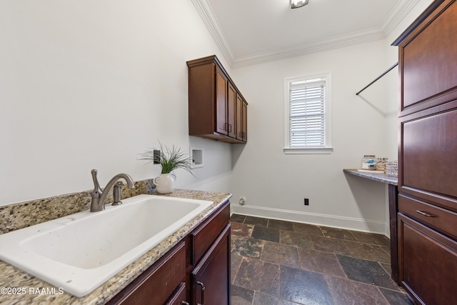 laundry area featuring ornamental molding, a sink, stone tile floors, baseboards, and hookup for a washing machine