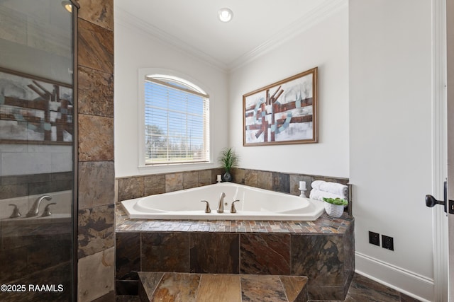 full bathroom with crown molding, a garden tub, baseboards, and a tile shower