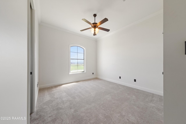 carpeted empty room featuring ceiling fan, baseboards, and ornamental molding