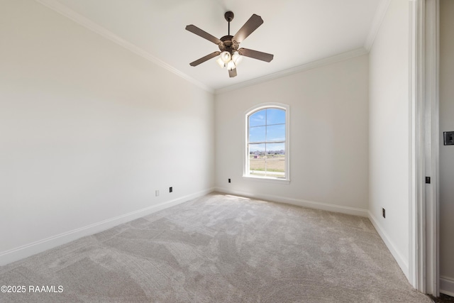 carpeted empty room featuring ceiling fan, baseboards, and ornamental molding