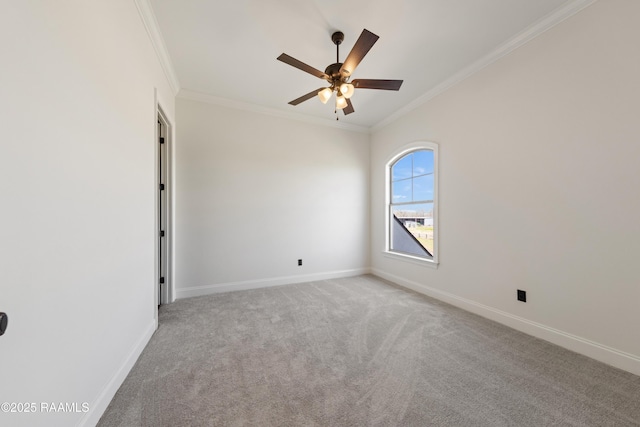 carpeted empty room featuring ceiling fan, baseboards, and ornamental molding