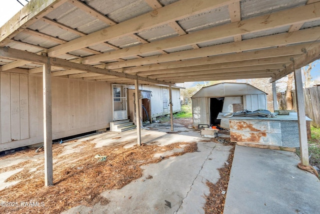 view of patio / terrace featuring entry steps, an outdoor structure, and a storage shed