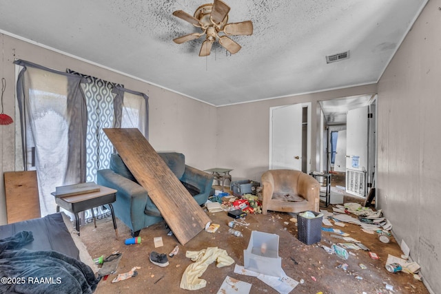 living area with ceiling fan, visible vents, a textured ceiling, and ornamental molding