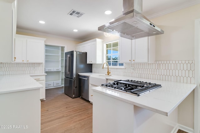 kitchen featuring ornamental molding, visible vents, appliances with stainless steel finishes, and island range hood