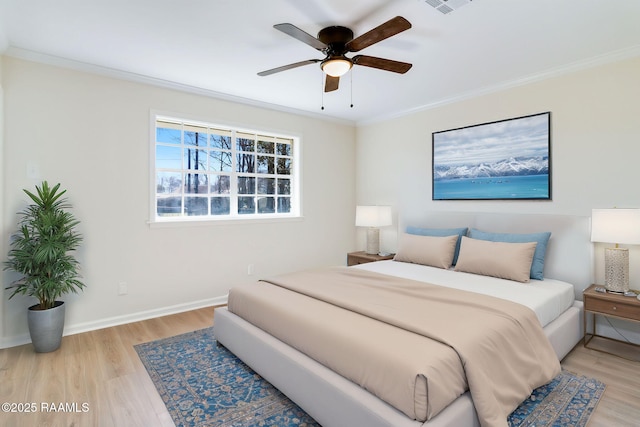 bedroom with light wood-type flooring, baseboards, and ornamental molding